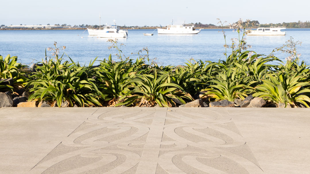 Maori kowhaiwhai pattern in concrete, looking out to boats in Tauranga harbour
